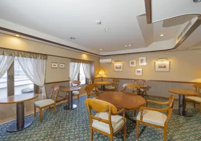 a restaurant with tables and chairs in a room at Saka no Hotel Tretio Ochanomizu in Tokyo