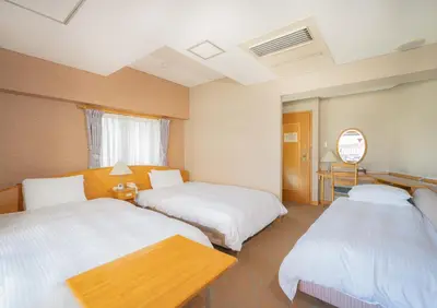 a hotel room with two beds and a table at Saka no Hotel Tretio Ochanomizu in Tokyo