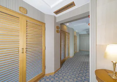 a hallway of a hotel with wooden doors and a lamp at Saka no Hotel Tretio Ochanomizu in Tokyo