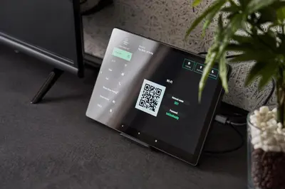 a laptop computer sitting on the floor next to a plant at TOKIO's HOTEL in Tokyo