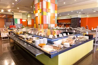 a buffet line in a restaurant with a lot of food at KOKO HOTEL Shinjuku Yotsuya- formerly Hotel Wing International Premium Tokyo Yotsuya in Tokyo