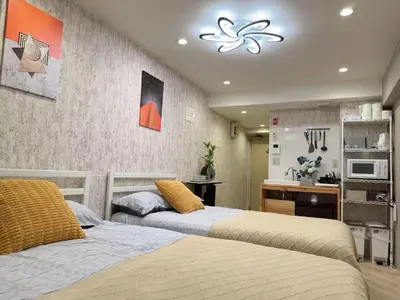 a bedroom with two beds and a desk in it at Shinjuku center2/4mins from Shinjuku sta./Max4 in Tokyo