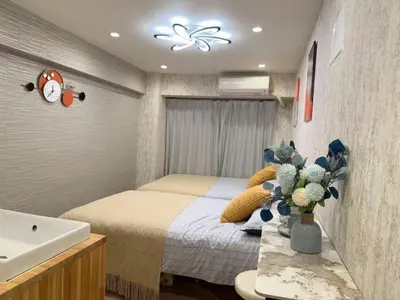 a small bedroom with a bed and a sink at Shinjuku center2/4mins from Shinjuku sta./Max4 in Tokyo