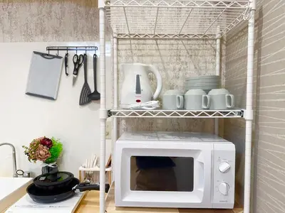 a microwave oven on a shelf in a kitchen at Shinjuku center2/4mins from Shinjuku sta./Max4 in Tokyo