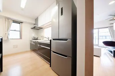 a kitchen with a stainless steel refrigerator and a sink at Generous Forest 301 in Tokyo