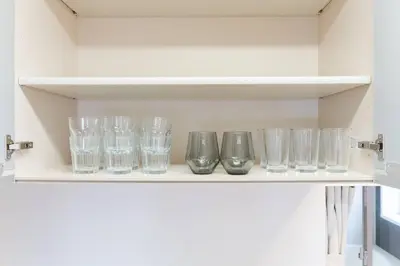 a row of glasses sitting on a shelf at Generous Forest 301 in Tokyo