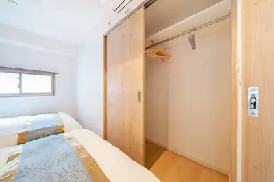 a small bedroom with a bed and a closet at Generous Forest 301 in Tokyo