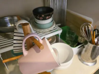 a pink tea pot sitting on a counter with dishes at shinookubo A room in Tokyo