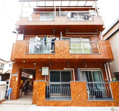 a brick building with balconies on the side of it at shinookubo A room in Tokyo