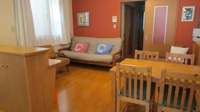 a living room with a couch and a table at Cheese Cozy Condo in Tokyo