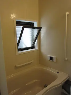 a bath tub in a bathroom with a window at Cheese Cozy Condo in Tokyo
