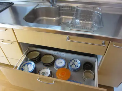 a drawer in a kitchen with dishes and a sink at Cheese Cozy Condo in Tokyo
