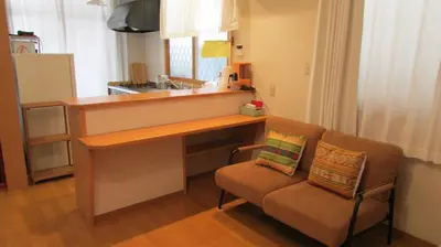 a kitchen with a desk and a couch and a sink at Cheese Cozy Condo in Tokyo