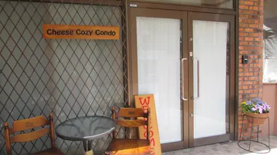 a coffee shop with a table and chairs in front of the door at Cheese Cozy Condo in Tokyo