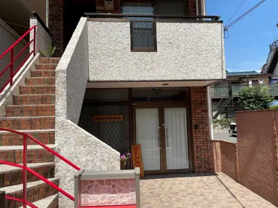 a brick building with a door and stairs in front at Cheese Cozy Condo in Tokyo
