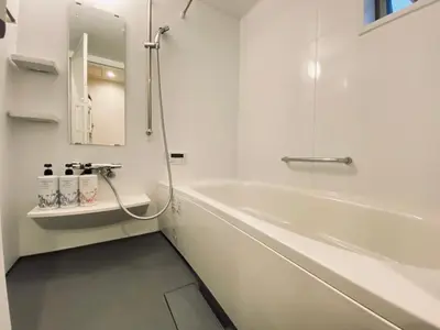 a white bathroom with a tub and a sink at ACOE HATSUDAI - 4BR Entire Home Upscale Area in Tokyo
