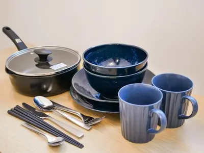 a group of cups and utensils on a table at Okubo Shinjuku new open Capsule hotel in Tokyo