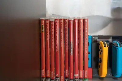 a row of books sitting on a shelf with scissors at \u677e\u5cf6\u96c5\u5c45 in Tokyo