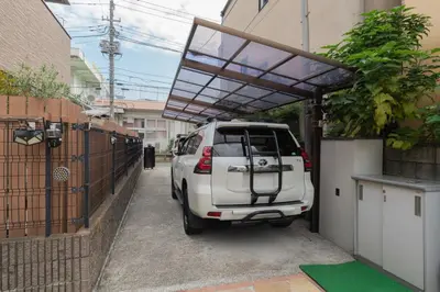 a white car parked under a garage with awning at \u677e\u5cf6\u96c5\u5c45 in Tokyo