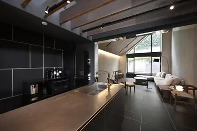 a kitchen with a counter and a living room at Kakurega Tokyo villa in Tokyo