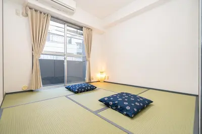 a room with two beds and a window at Two-bedroom, 6-minute walk to the Yamanote Line in Tokyo