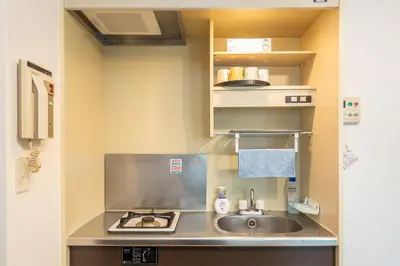 a small kitchen with a sink and a stove at Two-bedroom, 6-minute walk to the Yamanote Line in Tokyo
