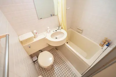 a bathroom with a toilet and a sink and a tub at Two-bedroom, 6-minute walk to the Yamanote Line in Tokyo