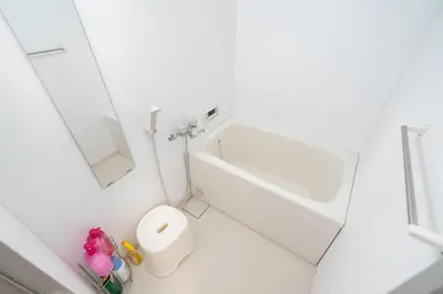 a white bathroom with a sink and a mirror at Ikebukuro East Exit Queen Bed Room, 2F in Tokyo