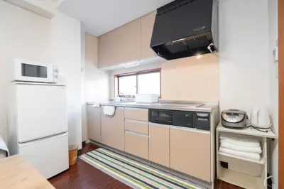 a small kitchen with a sink and a stove at Ikebukuro East Exit Queen Bed Room, 2F in Tokyo