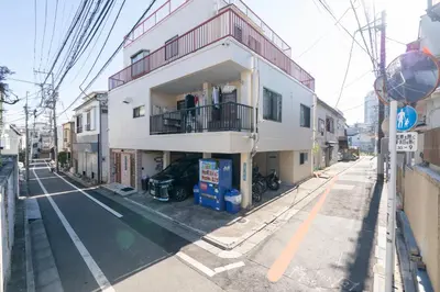 a white building on the side of a street at Ikebukuro East Exit Queen Bed Room, 2F in Tokyo