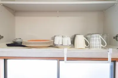 a kitchen counter with plates and mugs on it at Ikebukuro East Exit Queen Bed Room, 2F in Tokyo