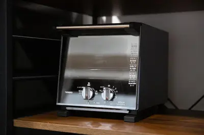 a microwave oven with two clocks on the screen at LUCKY house53 in Tokyo
