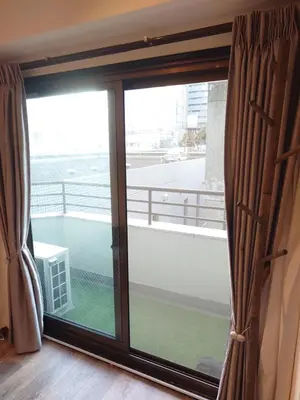 a large window with a view of a balcony at LUCKY house53 in Tokyo