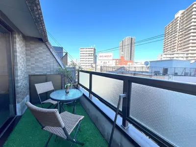 a balcony with two chairs and a table on it at Hotel Tokyo Hub in Tokyo