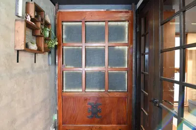 a wooden door with a window in a room at Hotel Tokyo Hub in Tokyo
