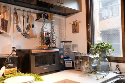 a kitchen counter with a microwave and a window at Hotel Tokyo Hub in Tokyo