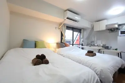 a room with two beds with teddy bears on them at LUANAHOTEL IN KABUKICHO in Tokyo