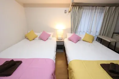 two beds sitting next to each other in a room at LUANAHOTEL IN KABUKICHO in Tokyo