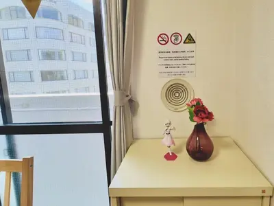 a table with a vase with a flower on it at Emoto Asakusa in Tokyo