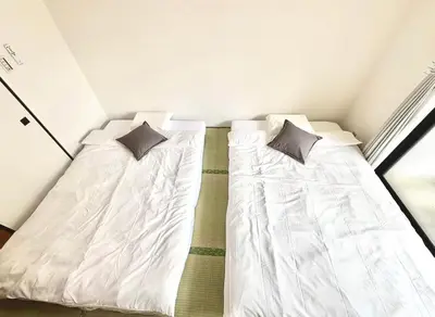 two beds sitting next to each other in a room at Emoto Asakusa in Tokyo