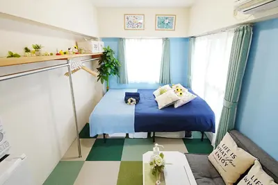 a small room with a bed and a couch at Kameari 811 Budget Stay High Floor Near Station Mall Disney Access in Tokyo