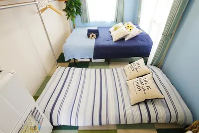 two twin beds in a small room with towels at Kameari 811 Budget Stay High Floor Near Station Mall Disney Access in Tokyo