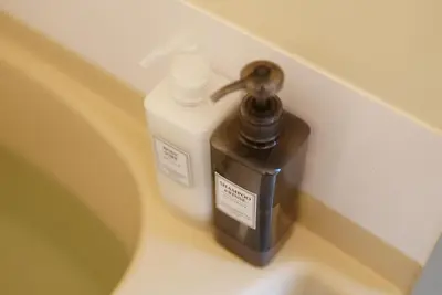a bottle of soap sitting on a bathroom counter at Kameari 811 Budget Stay High Floor Near Station Mall Disney Access in Tokyo