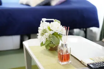 a vase of white flowers sitting on a table at Kameari 811 Budget Stay High Floor Near Station Mall Disney Access in Tokyo