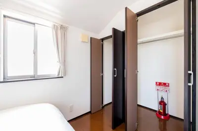 a bedroom with two sliding doors and a window at FUJIMI TOWN HOUSE in Tokyo
