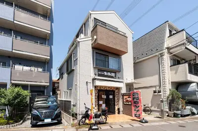 a building with a car parked in front of it at FUJIMI TOWN HOUSE in Tokyo