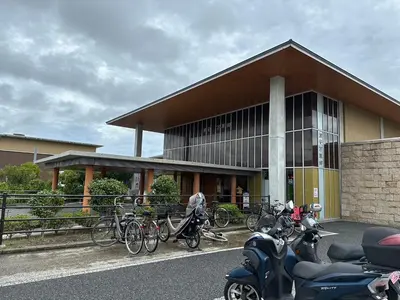 a building with bikes and motorcycles parked in front of it at FUJIMI TOWN HOUSE in Tokyo