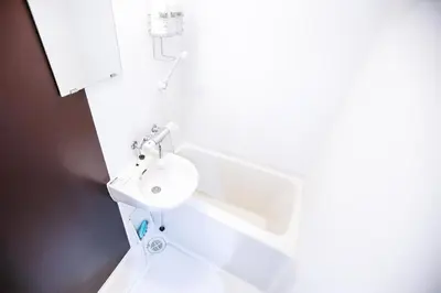 a white bathroom with a sink and a toilet at Shinjuku Ryokan Retreat丶Local Tokyo Experience & Short Trips Hub丶walk to Higahsi Shinjuku station LoE2 in Tokyo