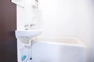 a white bathroom with a sink and a bath tub at Shinjuku Ryokan Retreat丶Local Tokyo Experience & Short Trips Hub丶walk to Higahsi Shinjuku station LoE2 in Tokyo