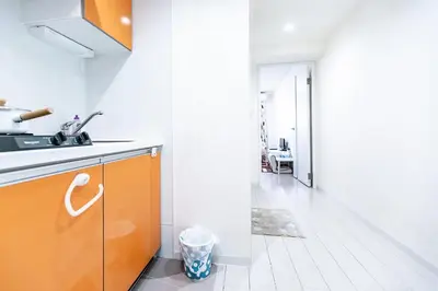 a kitchen with an orange cabinet and a hallway at Shinjuku Ryokan Retreat丶Local Tokyo Experience & Short Trips Hub丶walk to Higahsi Shinjuku station LoE2 in Tokyo